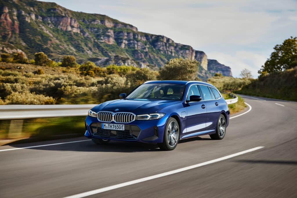 BMW 330e Touring driving on windy road.